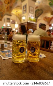 Munich, Germany - 04.07.2022: Famous Hofbräuhaus Traditional Pud Keller In Munich 2 HB Beer Jugs Krügel