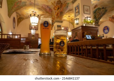 Munich, Germany - 04.07.2022: Famous Hofbräuhaus Traditional Pud Keller In Munich 2 HB Beer Jugs Krügel