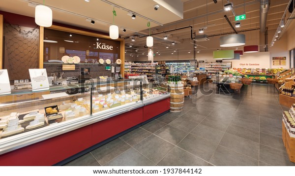 Munich, Germany - 2021 02 05: Entrance area in\
german organic supermarket with cheese section and vegetables and\
fruits department