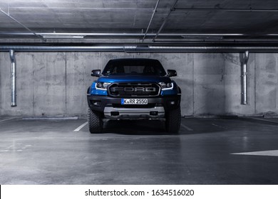 Munich Germany 3 February 2020 Ford Ranger Raptor T6 Mid-size Pickup Truck Stand On Parking Slot In Modern Garage. Front View With Led Light On. 