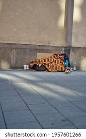 MUNICH, GERMANY - Apr 04, 2021: A Homeless Man Lies In His Sleeping Bag On The Street  Many Beggars In The Center Of Munich 