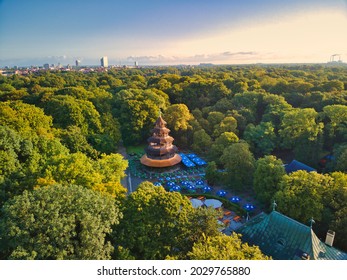 MUNICH, GERMANY - Aug 17, 2021: Aerial view of chinese tower in english garden munich  Historic building is a popular beer garden in central park of bavarian capital