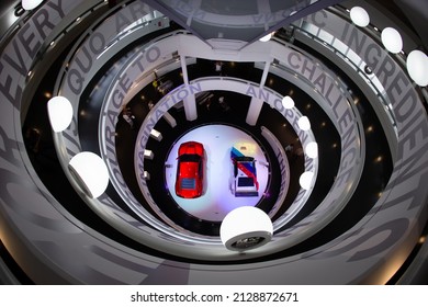 Munich, Germany - August 5, 2014: A 2008 BMW M1 Hommage  And 1978 BMW M1 Race Car Are On Display Inside The BMW Museum, Shot From Above Down Of A Spectacular Spiral Staircase