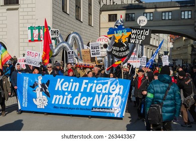 Munich, Germany - February 7, 2015: European anti-NATO peaceful protest demonstration. Texts on banners and placards says: Stop North Atlantic Alliance eastward expansion, No friendship with NATO.