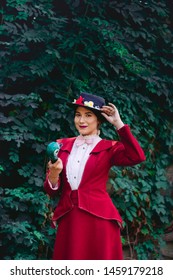 Munich, Germany - July 21, 2019: Young lady woman cosplay as mary poppins green background