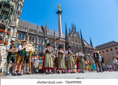 MUNICH, GERMANY - JULY 25, 2017: Music band in traditional bavarian clothes in front of Marienplatz town hall in Munich, Germany in a beautiful summer day