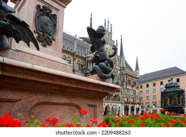 Munich, Germany - July 4, 2011 : Figures Of Angels Slaying Dragons At Base Of Mariensaule (Mary's Column) At Marienplatz.