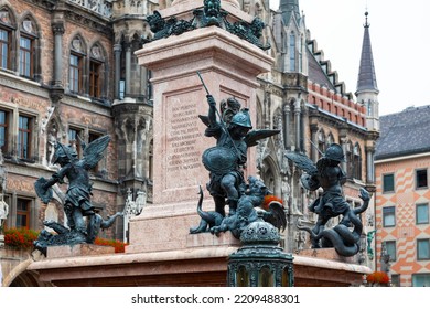 Munich, Germany - July 4, 2011 : Figures Of Angels Slaying Dragons At Base Of Mariensaule (Mary's Column) At Marienplatz.