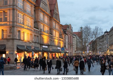 Munich, Germany - Mar 09 2019. Crowded Pedestrian zone, inner city of Munich between Marienplatz and Karlsplatz with storefronts in the evening