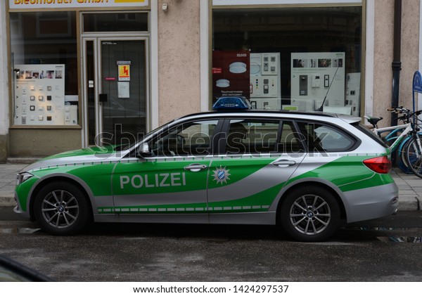 MUNICH, GERMANY - MARCH 6, 2016: BMW\
F31 Touring Police (German: Polizei) car on duty in the Munich city\
street. Classic police cars green colors in\
Germany.