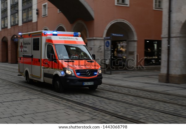 MUNICH, GERMANY -\
MARCH 6, 2016: Mecedes-Benz Sprinter Ambulance Emergency van  of\
the Bavarian Red Cross (German: Bayerisches Rotes Kreuz) car on\
duty on the Munich city\
street