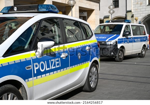 Munich, Germany, May\
2022: Police patrol car parked on the street in Germany. German\
police cars on the street. Side view of a police car with the\
lettering \