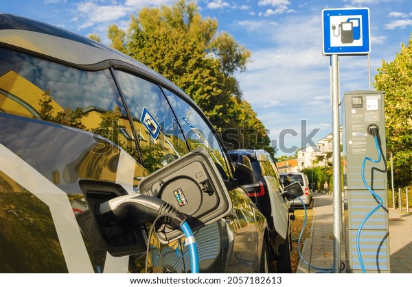 Munich, Germany, Oct. 3, 2021:\
Electric battery cars charging at a  station in a rural\
surrounding. Electric mobility is an environmentally friendly way\
of transport.