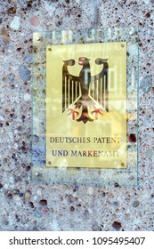 Munich, Germany - October 20, 2017:  Wall signboard of the German patent office with the coat of arms