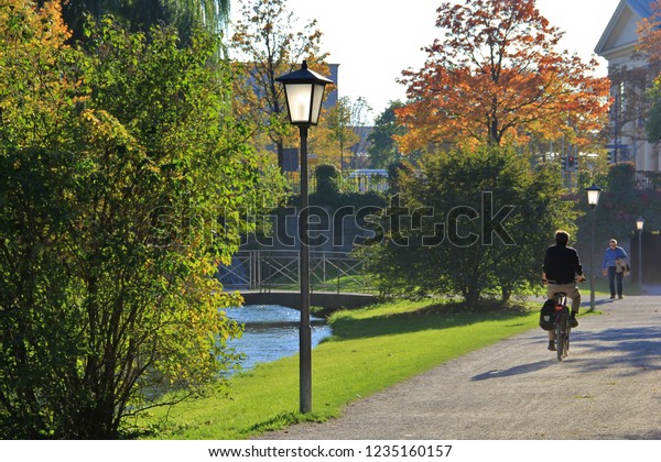 Munich, Germany - October,2018: Man riding the\
bike to the office to start a working day instead of taking a car\
or subway. Concept of healthy lifestyle and physical exercise\
commuting to workplace