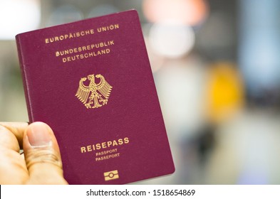 Munich, Germany - September 29 2019: Passenger holding German passport at the airport in Munich, Germany