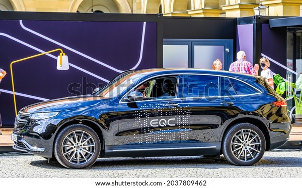 Munich, Germany - September 7: Audience at a car\
manufacturer\'s booth at the IAA (Internationale Auto Ausstellung -\
translation: international auto exhibition) trade fair in Munich on\
September 7,2021