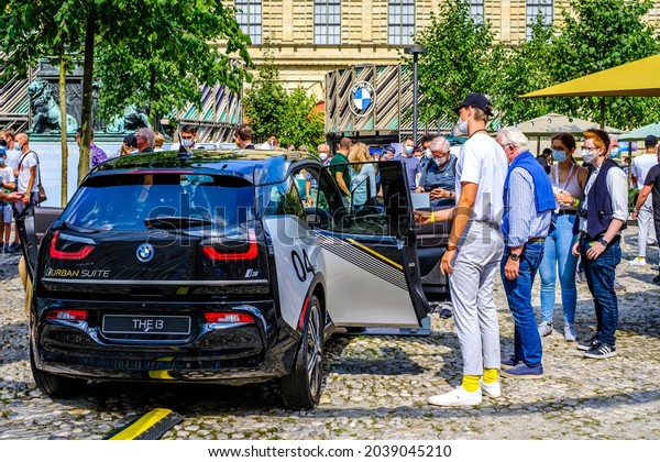 Munich, Germany - September 9: Audience at a car\
manufacturer\'s booth at the IAA (Internationale Auto Ausstellung -\
translation: international auto exhibition) trade fair in Munich on\
September 9,2021