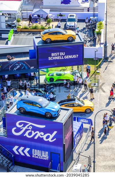 Munich, Germany - September 9: Audience at a car\
manufacturer\'s booth at the IAA (Internationale Auto Ausstellung -\
translation: international auto exhibition) trade fair in Munich on\
September 9,2021