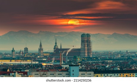 Munich Skyline aerial view at sunset, munich sunset frauenkirche church townhall marienplatzin background alps mountains.