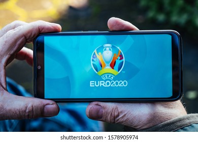 MUNICH/GERMANY - December 2019: Man Is Holding A Smartphone With Logo Of UEFA Euro 2020 On Screen