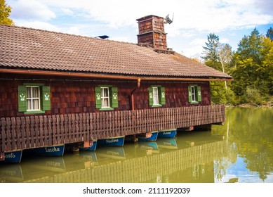 Munich-Germany-October 04,2020: Rowboats for rent float moored under a house.
