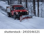 Municipal Snow Plow Truck clearing snow during heavy snowstorm snow falling snow removal