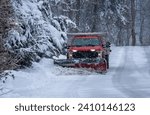 Municipal Snow Plow Truck clearing snow during heavy snowstorm snow falling snow removal