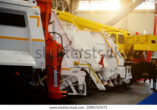 Municipal waste collection equipment and\
construction crane.