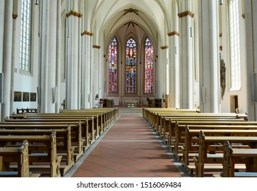 Munster, Germany - 06 24 2019: Interior View Of A Large Bright Church And Stained Glass With Empty Benches. St. Lamberti Church In Munster.