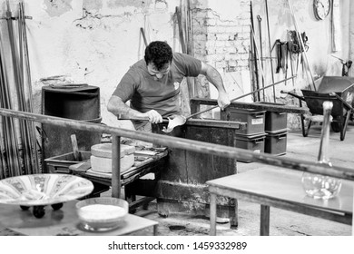 Murano Island, Italy - April 23, 2017: Glassblowing Artisan At Work In A Crystal Glass Workshop In Murano Island, Venice. 