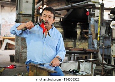 MURANO - MAY 01 2011:Master Glassblowing Artisan At Work In A Crystal Glass Workshop In Murano Island Venice Italy.Murano Glassmakers Use The Same Tools As Their Ancestors Have Thousands Of Years Ago