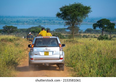 Murchison Falls National Park, Uganda - January 2, 2022: Safari Cars Driving On The Rural Road Of Savannah, Watching Wildlife Animals