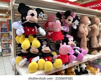 MURCIA, SPAIN - NOVEMBER 2, 2021: Many Stuffed Dolls Are Displayed On A Shelf In A Spanish Supermarket In The Toy Aisle. The Most Famous Are Mickey, Minnie And Peppa Pig..