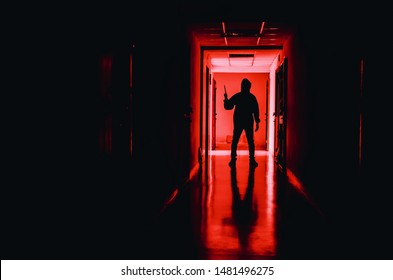 murder, kill and people concept - Criminal or murderer wearing a mask in silhouette holding knife inside a condo at crime scene - Shutterstock ID 1481496275