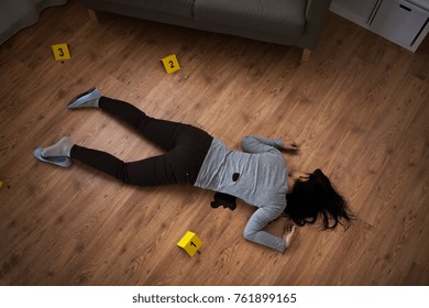 Murder, Kill And People Concept - Dead Woman Body In Blood Lying On Floor And Bullet Sleeves At Crime Scene (staged Photo)