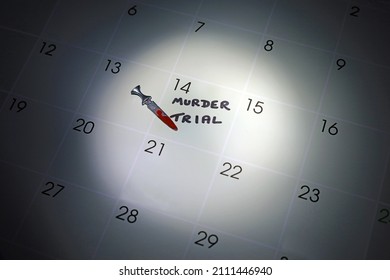 Murder Trial Written On A Calendar With A Blood Stained Dagger Under The Spotlight.