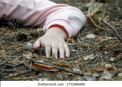 Murder In The Woods.The Hand Of A Dead Teenager In The Forest On The Ground. Victim Of Violence. The Concept Of Child Abuse. Close Up.