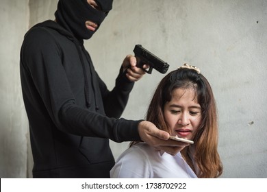 Murderer Or Terrorist Man Holding Gun Intimidate Young Woman For Call Money Hostage