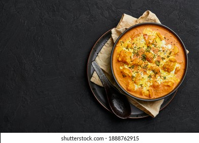 Murgh Makhani Or Butter Chicken In Black Bowl On Dark Slate Table Top. Indian Cuisine Dish With Chicken Meat And Creamy Masala. Asian Food And Meal. Copy Space. Top View