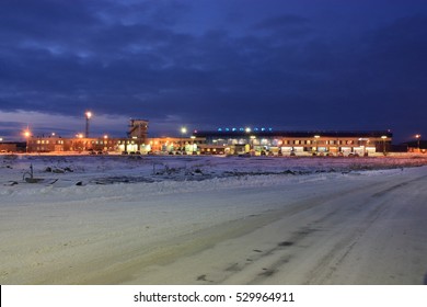 Murmansk, Russia - November 25, 2008: The Road To The Airport In Winter. In The North Of Russia In The Morning Is Still Very Dark, You Can See The Bright Lights Of The Building And Parking Lot.