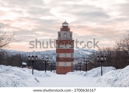 Murmansk in winter. The lighthouse tower is part of the memorial complex in memory of sailors who died in peacetime