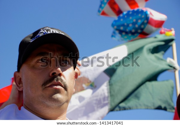 Murrieta, CA / USA - July 7 2014: Protesters\
and counter-protesters gather near a US Customs and Border\
Protection facility used to house undocumented immigrants during a\
surge in border\
crossings.