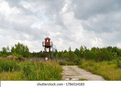 Murru / Rummu Soviet Slave Labour Prison Complex Abandone Watch Tower. Old Overgrown By Nature And Rusty Prison Wall With Watchtower.