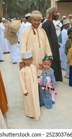 MUSCAT, OMAN - FEBRUARY 1, 2008: A Proud Omani Father With His Two Young Children, All Immaculately Dressed In Traditional Clothing, In Muscat In The Sultanate Of Oman.