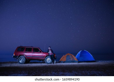 Muscat, Oman - January 10 2020 : Jeep Cherokkee On Road Trip And Camping At Night