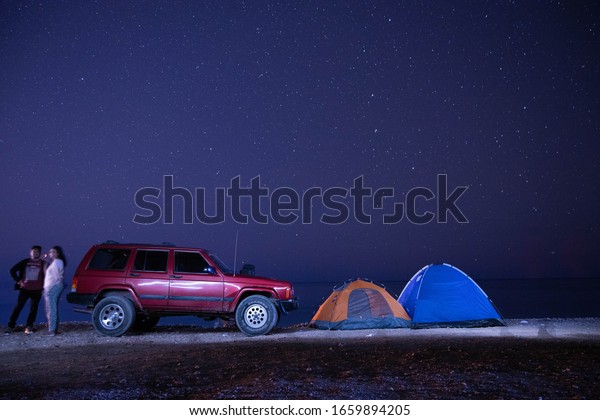Muscat, Oman - January 10 2020 : Jeep Cherokkee on\
Road trip and camping at\
night