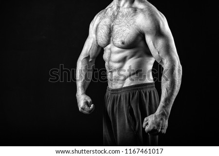 Muscle concept. Muscle torso with six pack abs of man, black and white. strong man isolated on black. Always in good shape.