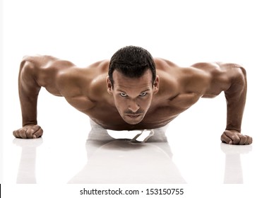 Muscle man dmaking push ups in studio, isolated over a white background - Powered by Shutterstock