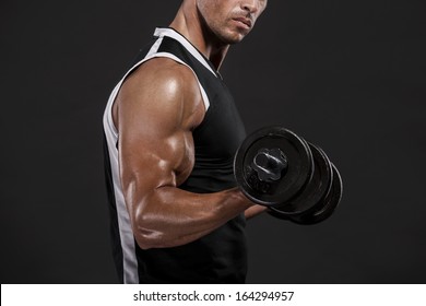 Muscle Man In Studio Lifting Weights, Isolated Over A White Background